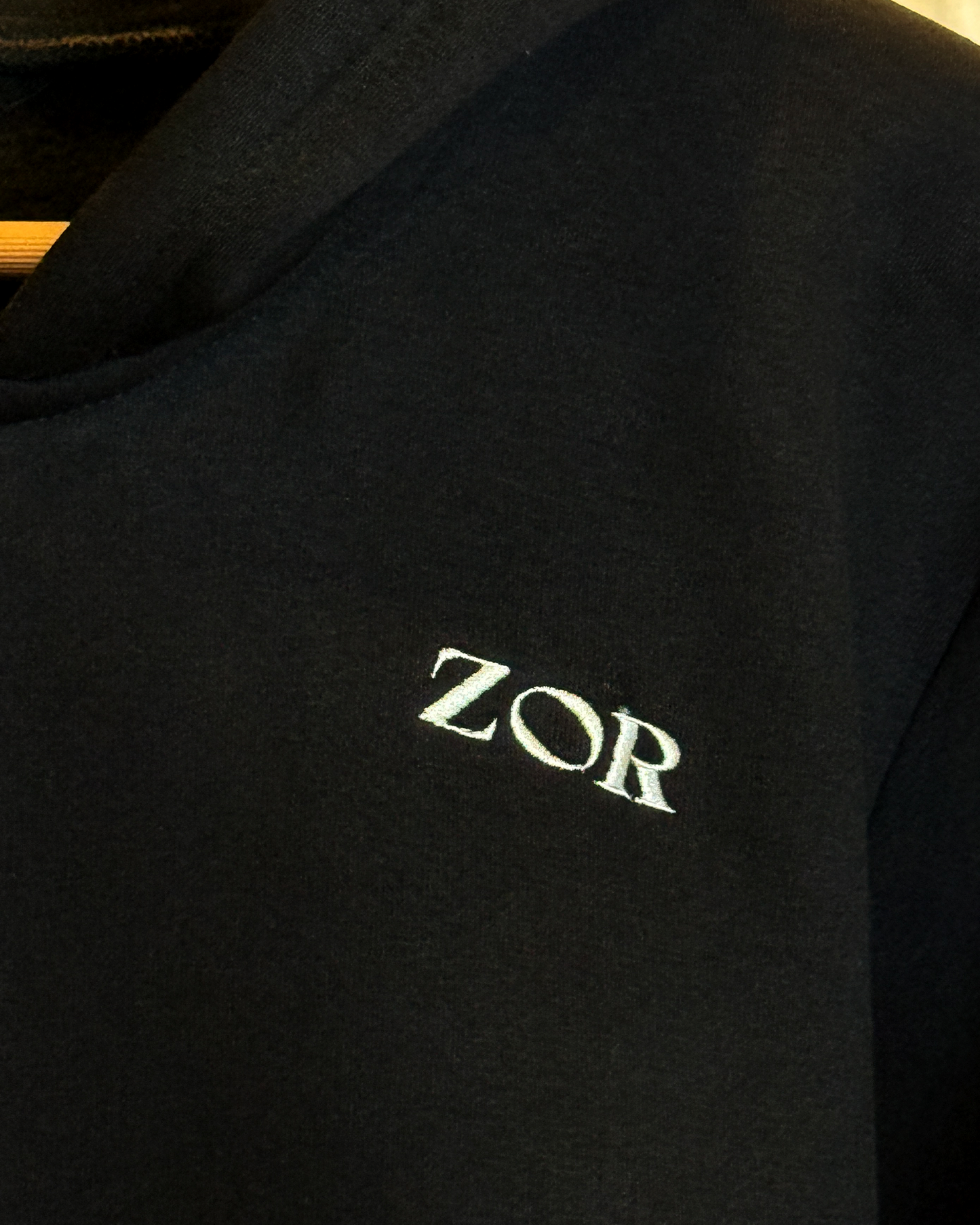 Zor Black Hoodie, Hoodies for Men, Hoodies for Women, Black hoodie with 'ZOR' logo on a dark background