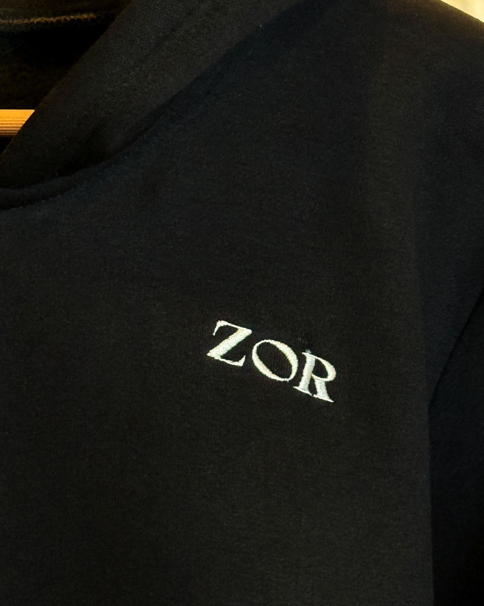 Zor Black Hoodie, Hoodies for Men, Hoodies for Women, Black hoodie with 'ZOR' logo on a dark background