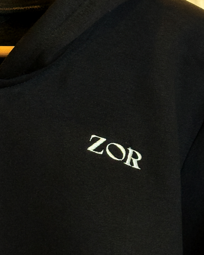 Zor Black Hoodie, Hoodies for Men, Hoodies for Women, Black hoodie with 'ZOR' logo on a dark background